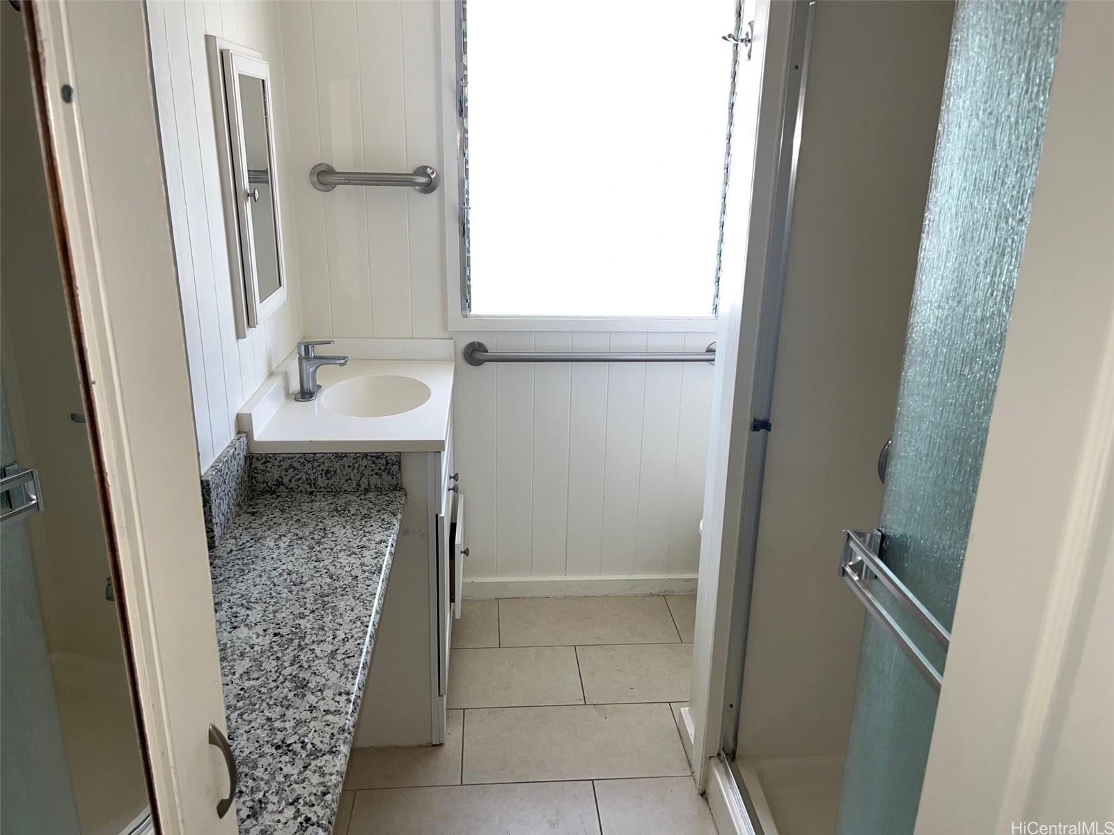 2153 Booth Road Honolulu, HI 96813 - Photo 6 of 18 a bathroom with a granite countertop sink and a mirror