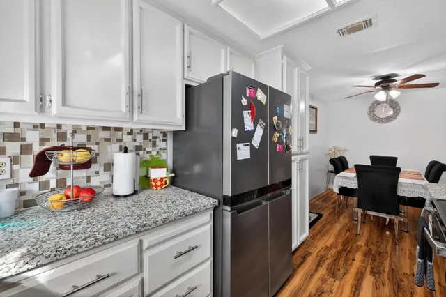 a kitchen with refrigerator and cabinets