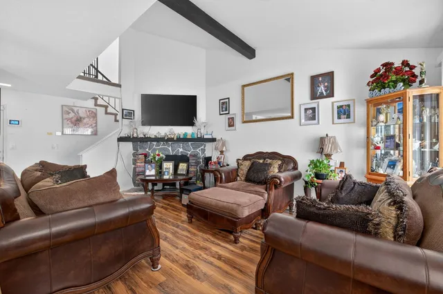 a living room with fireplace furniture and a flat screen tv