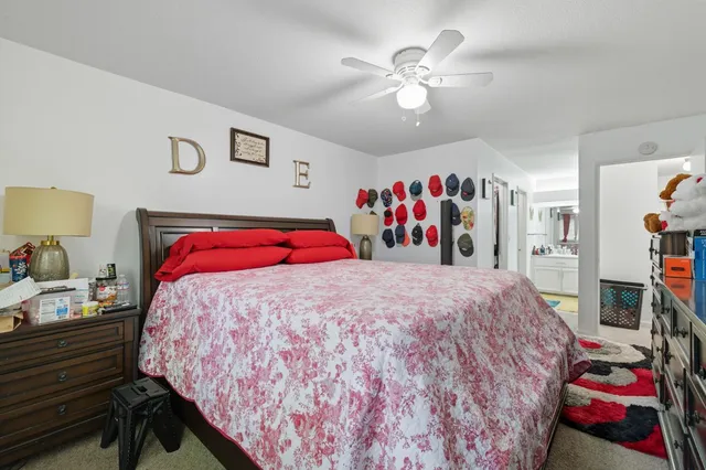 a bedroom with bed and book shelf