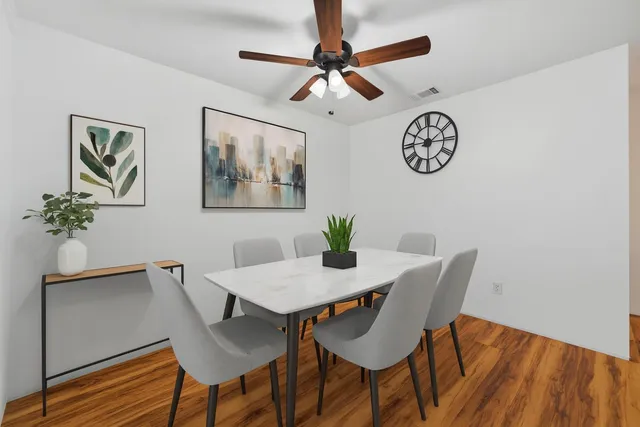 a view of a dining room with furniture and wooden floor