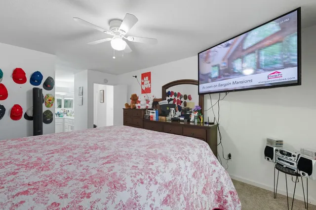 a bedroom with a bed and a view of kitchen