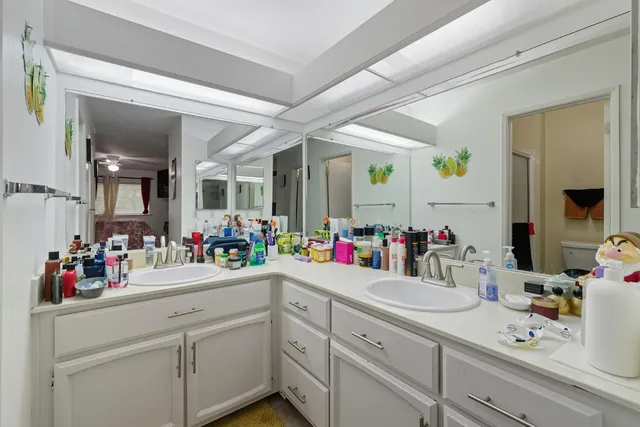 a bathroom with a sink mirror and double vanity