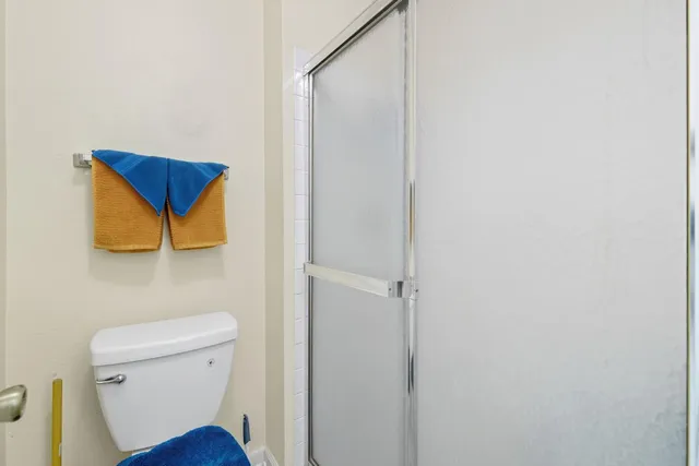 a bathroom with a toilet and a shower curtain