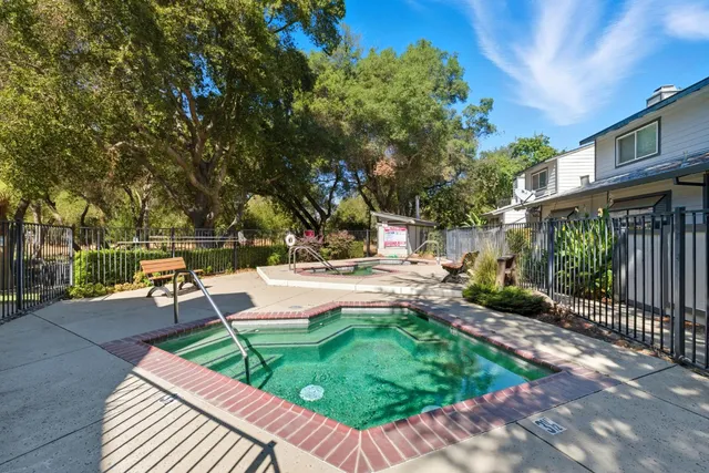a view of swimming pool with outdoor seating and plants