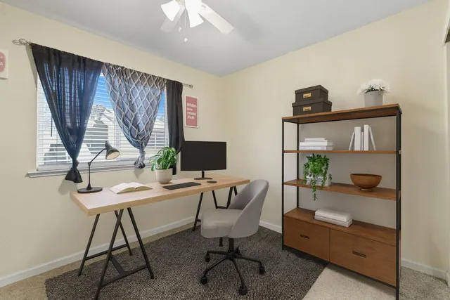 a work room with furniture and a window