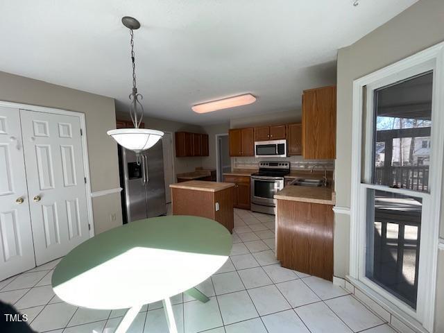 107 Glen Alpine Circle Cary, NC 27513 - Photo 7 of 17 a kitchen with stainless steel appliances kitchen island granite countertop a refrigerator a stove a sink dishwasher with a dining table and chairs