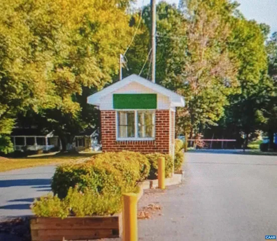 a front view of a house with swimming pool and sitting area