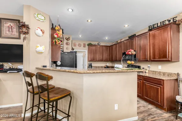 a kitchen with stainless steel appliances granite countertop a sink and a refrigerator