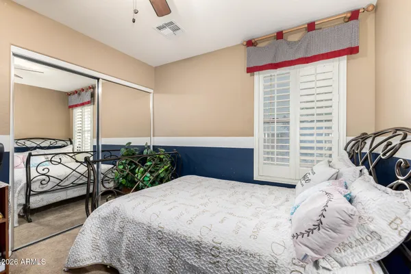 a blue bed sitting in a room next to a window