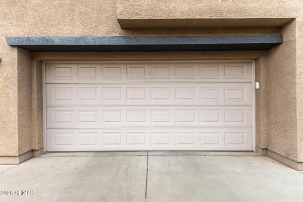 a front view of a house with a garden and lake view
