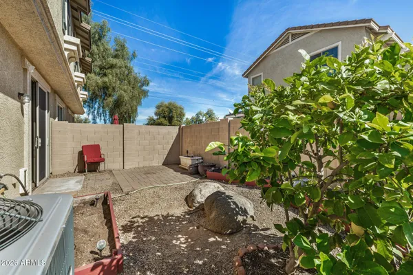 a view of a yard with a house in the background