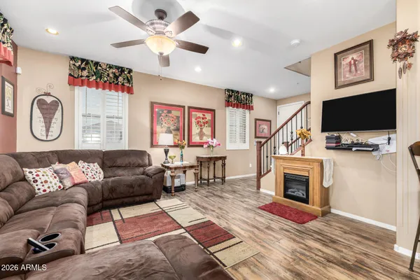 a living room with furniture a fireplace and a flat screen tv