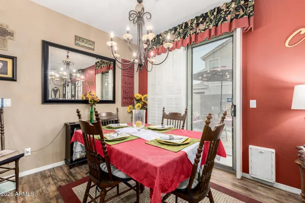 a view of a dining room with furniture and a chandelier