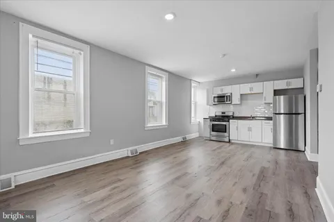 a view of kitchen with wooden floor and electronic appliances