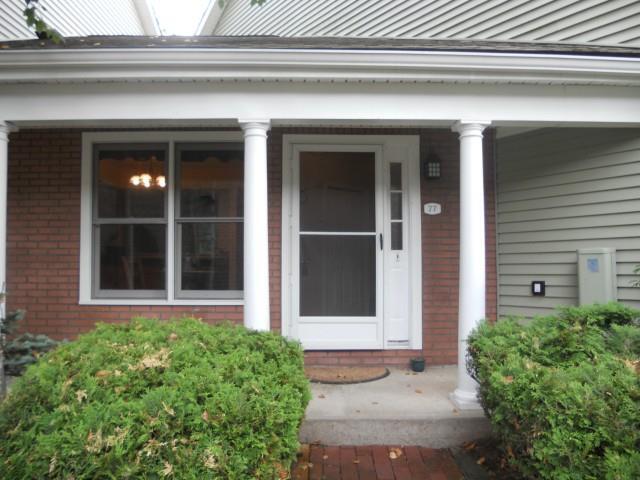 1 East Hayestown Road, Unit 77 Danbury, CT 06811 - Photo 1 of 1 a front view of a house with a yard and plants
