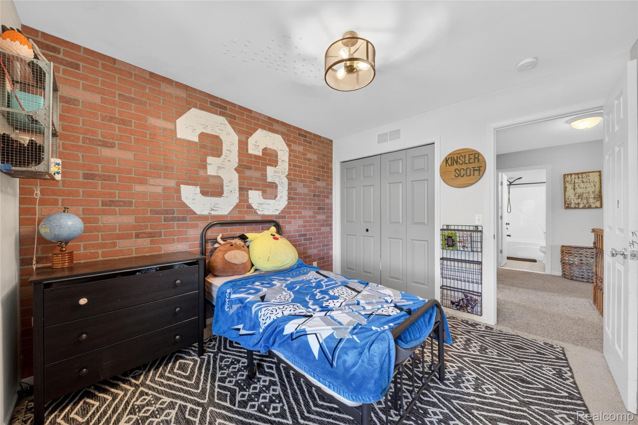 9191 Judd Road Fowlerville, MI 48836 - Photo 54 of 74 Exposed brick accent wall with painted graphic detail
