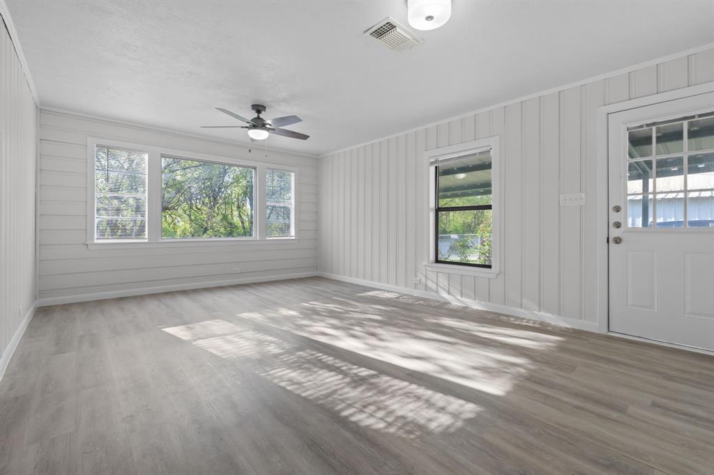 217 Clinton Drive Weatherford, TX 76086 - Photo 3 of 19 a view of an empty room with wooden floor and a window