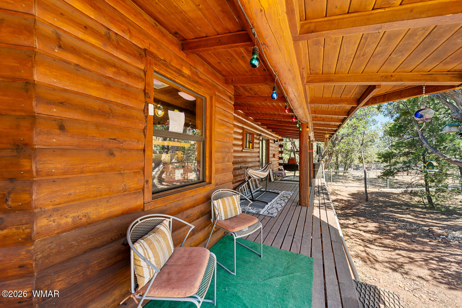 6720 Cheney Ranch Loop Show Low, AZ 85901 - Photo 12 of 55 a view of a patio with table and chairs with wooden floor and fence