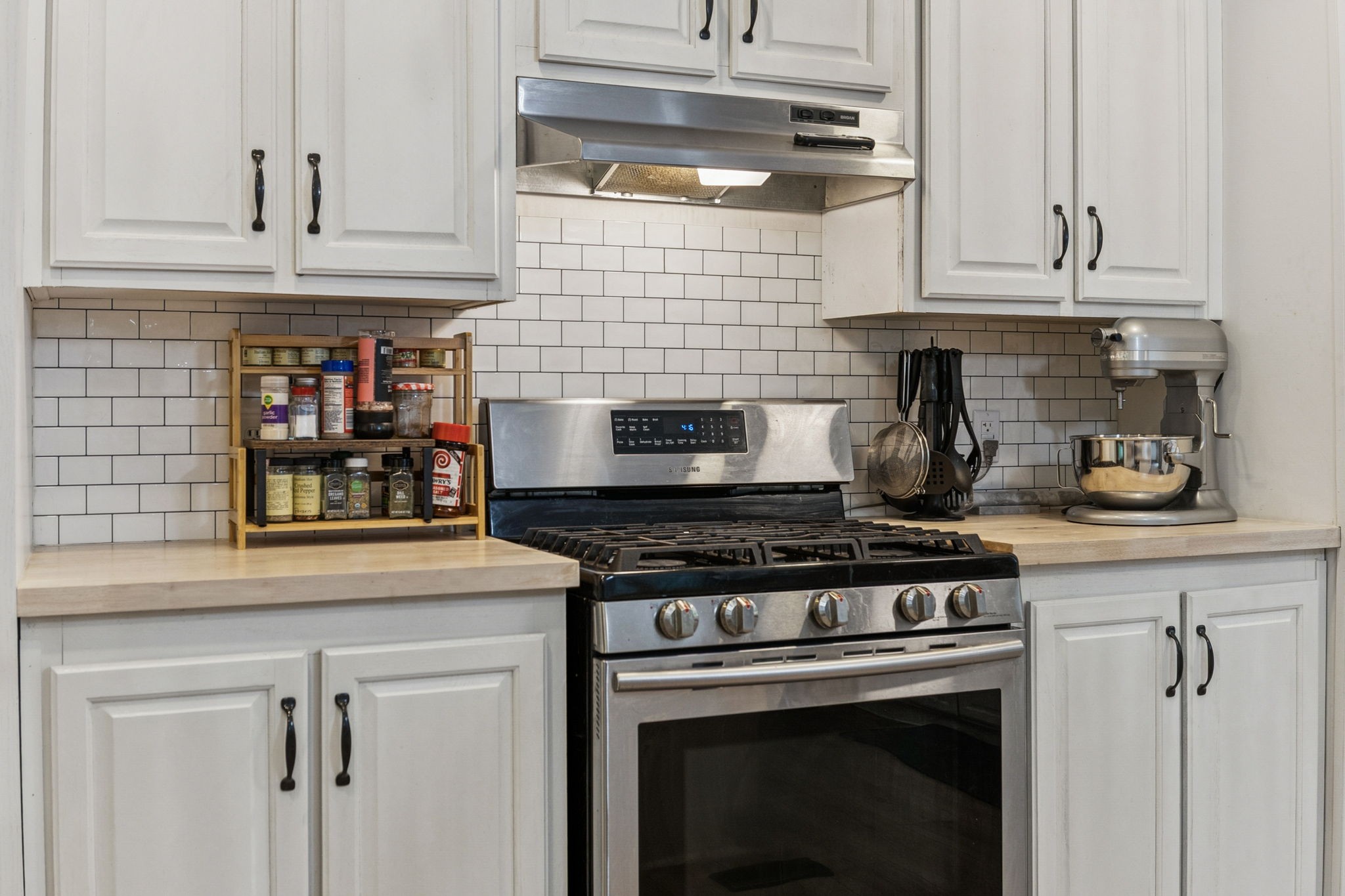 a stove top oven sitting inside of a kitchen