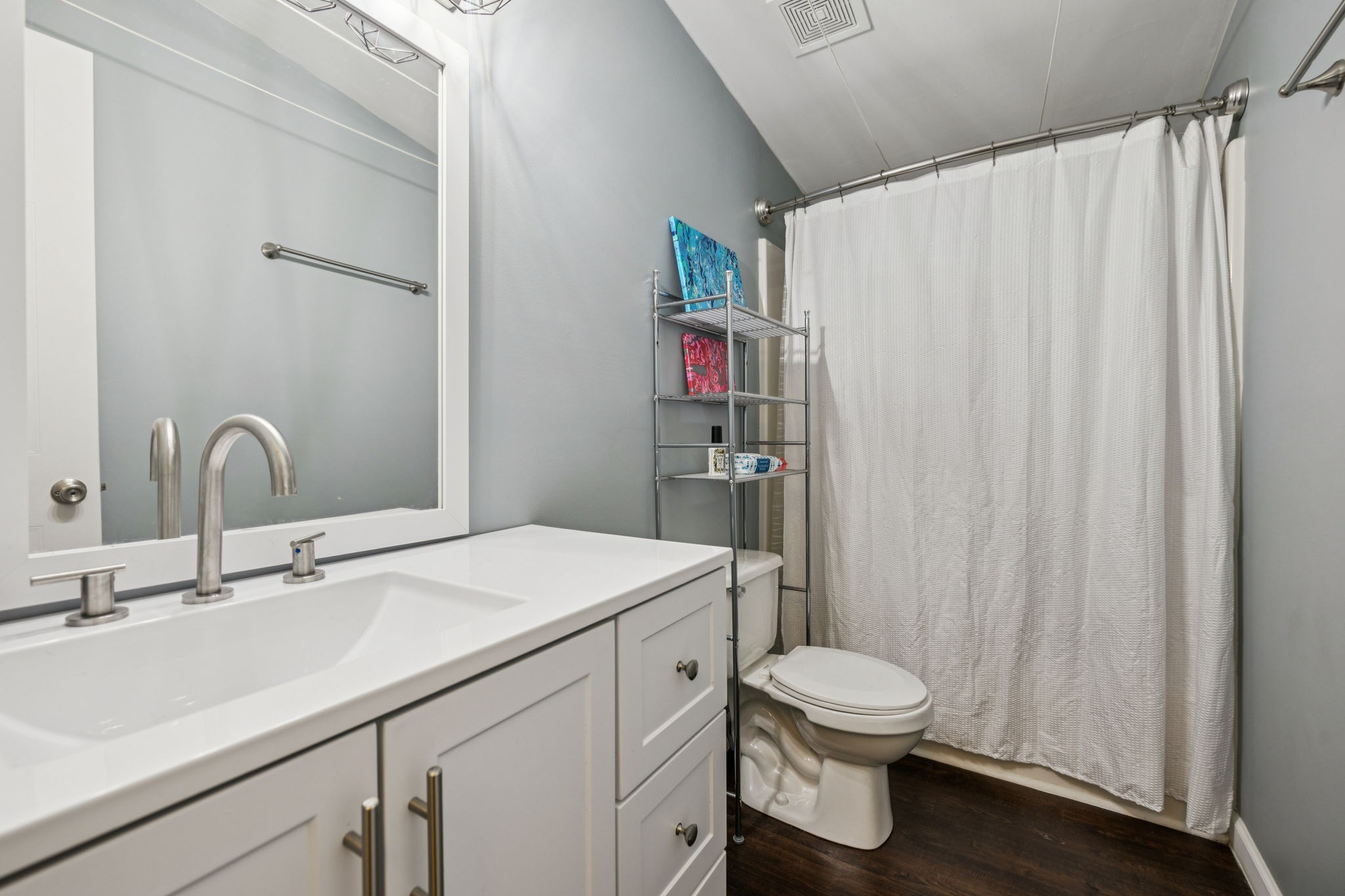 3063 Sweethome Road Chapmansboro, TN 37035 - Photo 23 of 46 a bathroom with a sink a toilet and shower curtain