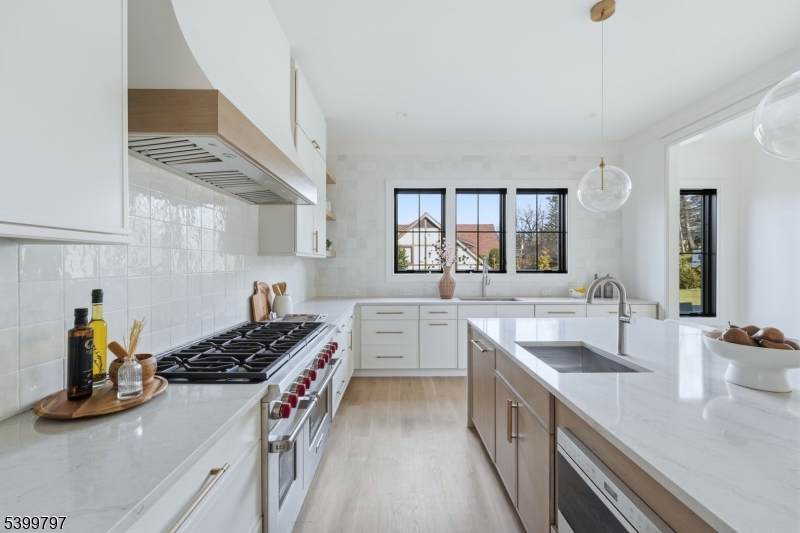 15 Sparta Road Short Hills, NJ 07078 - Photo 6 of 16 a kitchen with a sink stove and wooden cabinets