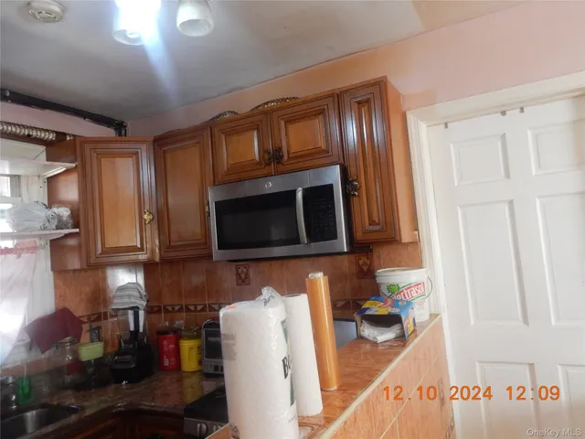 a kitchen with stainless steel appliances granite countertop a stove microwave and cabinets