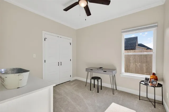 a view of a workspace with furniture and a window