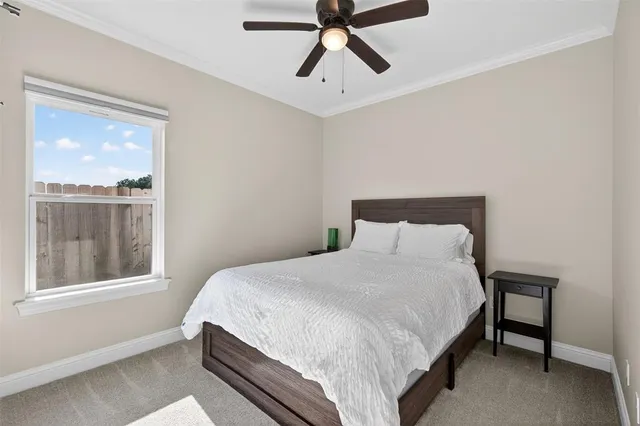 a bed sitting in a bedroom next to a window