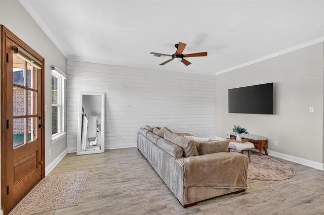 a living room with furniture and a flat screen tv