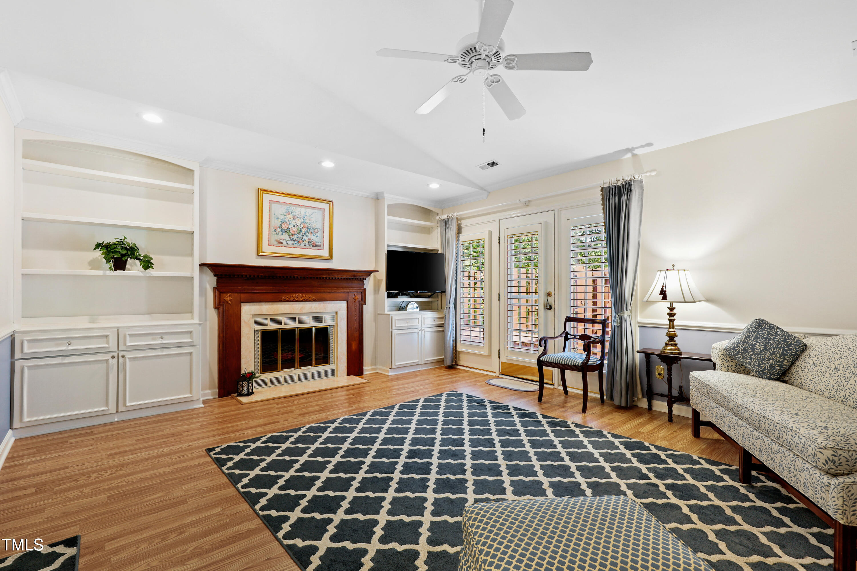 2617 Cottage Circle Raleigh, NC 27613 - Photo 4 of 27 a living room with furniture a flat screen tv and a fireplace