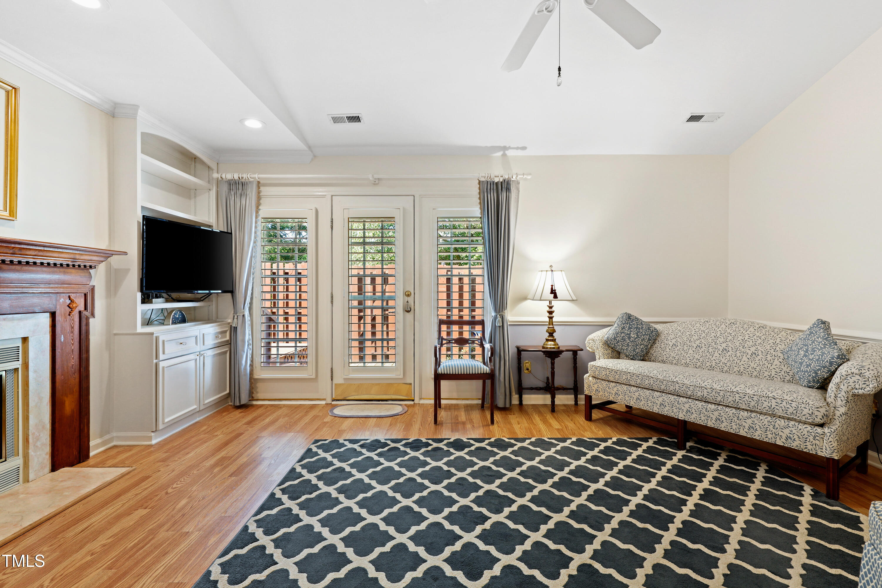 2617 Cottage Circle Raleigh, NC 27613 - Photo 5 of 27 a living room with furniture a flat screen tv and a fireplace