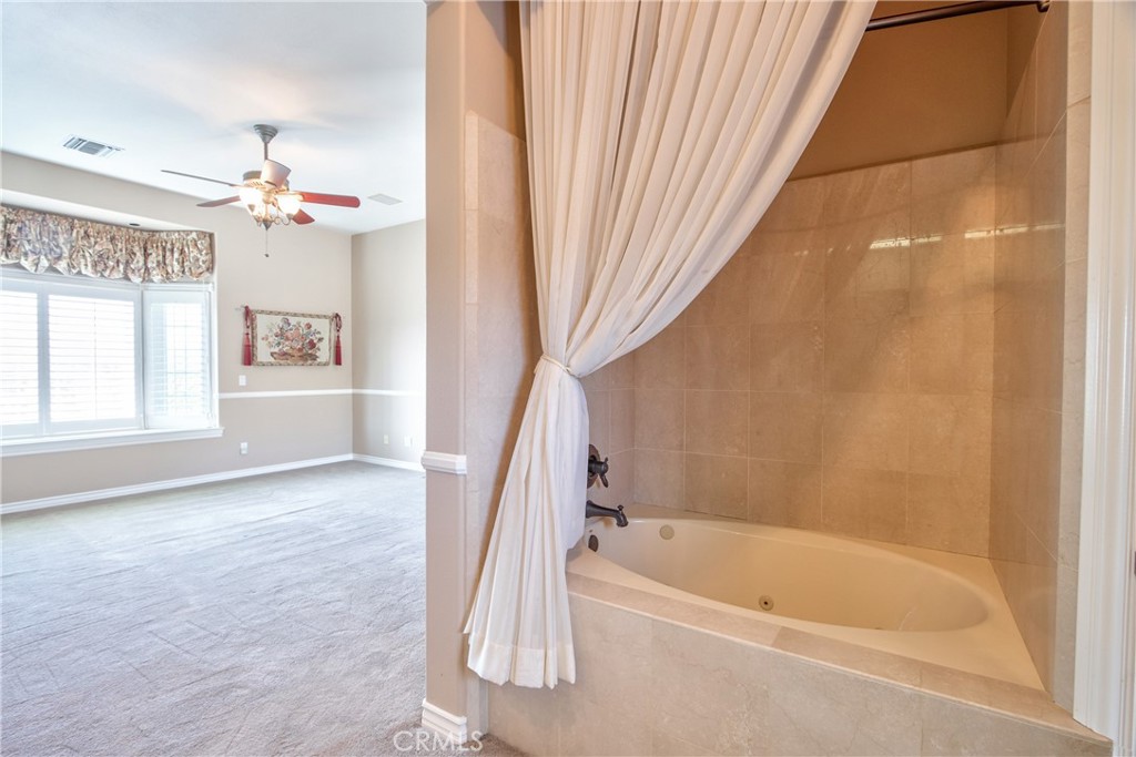 46856 El Prado Road Temecula, CA 92590 - Photo 46 of 75 a bathroom with a bathtub sink and a shower