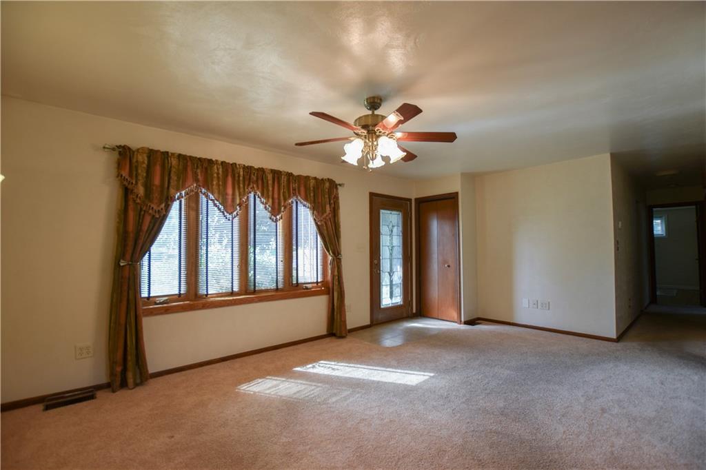 219 A Meridian Road Butler, PA 16001 - Photo 5 of 43 an empty room with windows and chandelier fan