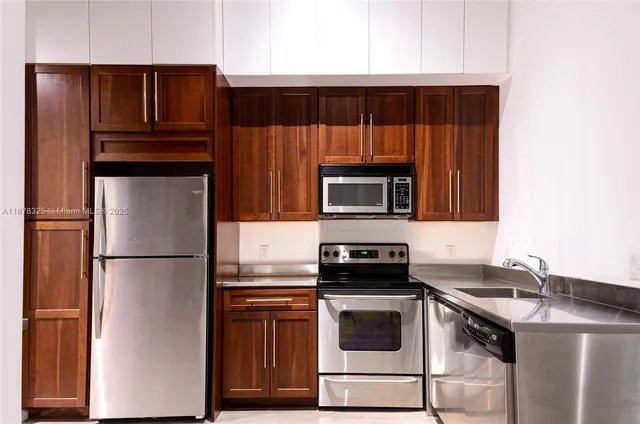 a kitchen with a refrigerator stove and microwave