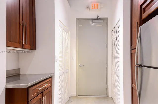 a kitchen with refrigerator and cabinets