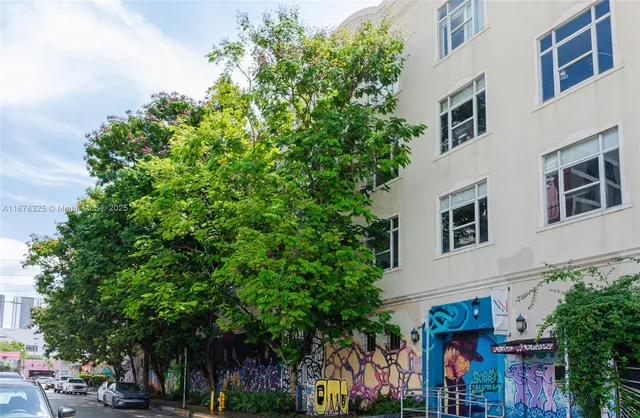 front view of a building with a tree