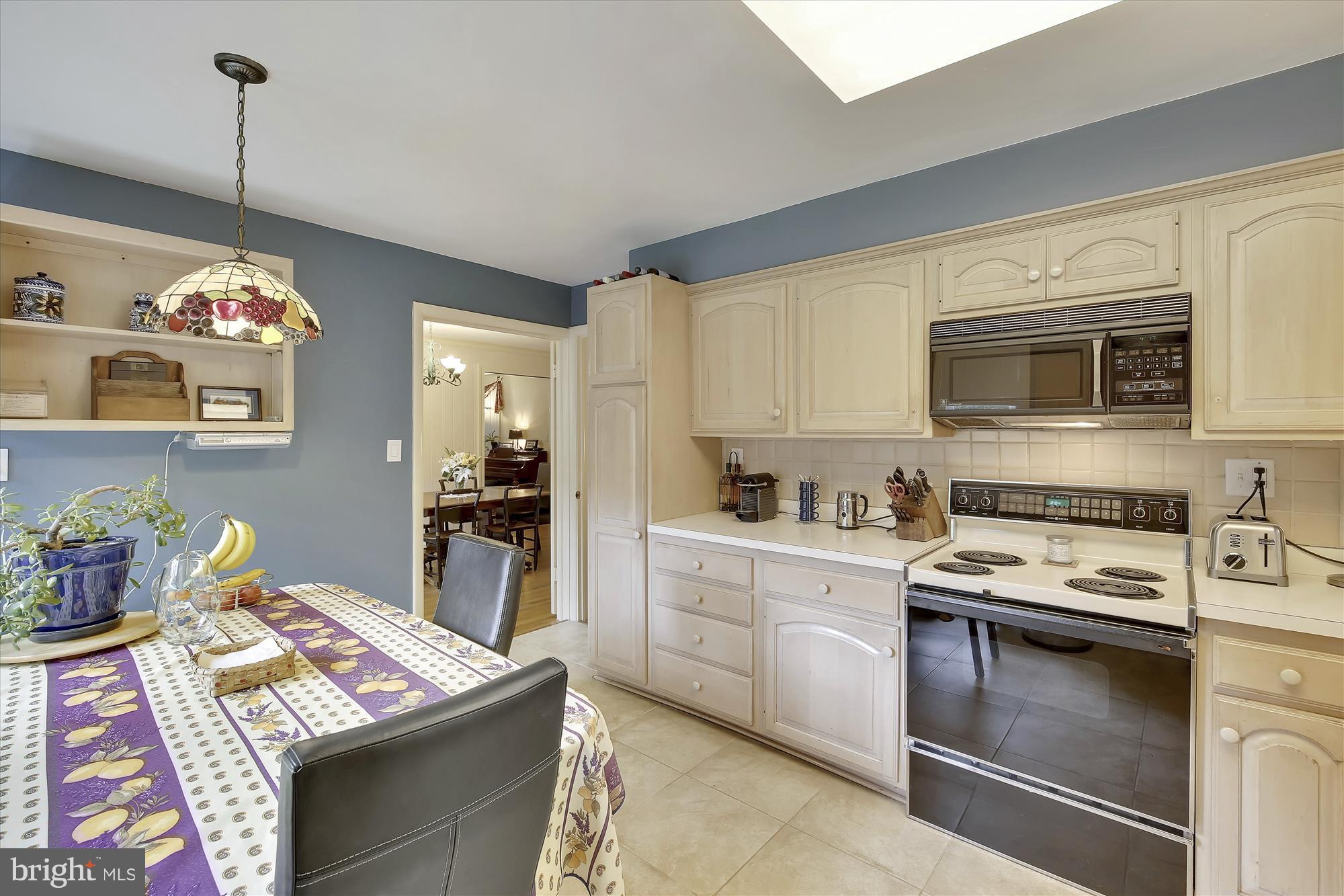 9121 Seven Locks Road Bethesda, MD 20817 - Photo 8 of 30 a kitchen with stainless steel appliances granite countertop a sink dishwasher stove top oven and cabinets with wooden floor