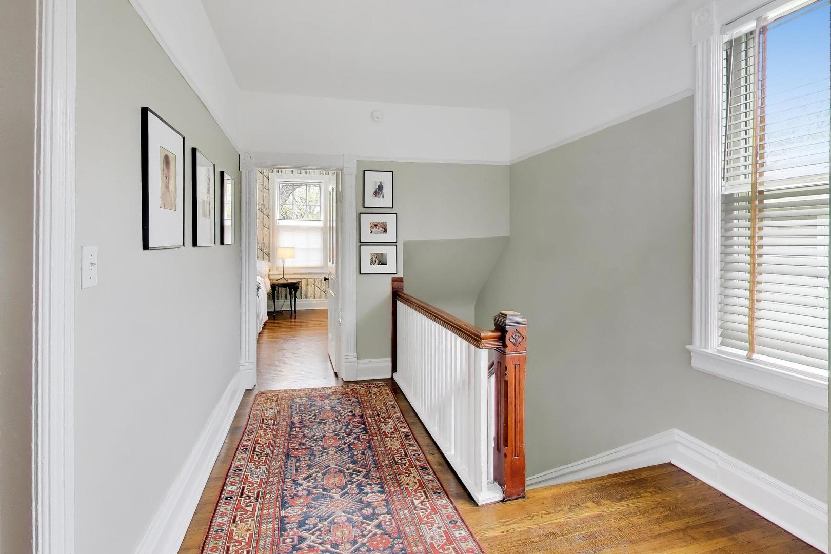 1235 Maple Avenue Evanston, IL 60202 - Photo 26 of 57 a view of a hallway with furniture and wooden floor
