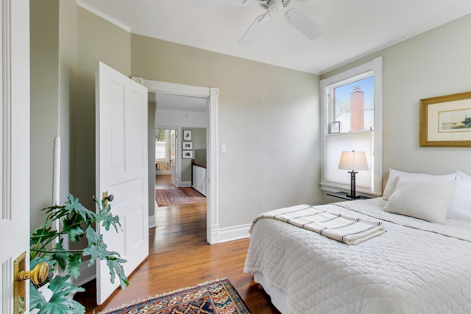 1235 Maple Avenue Evanston, IL 60202 - Photo 34 of 57 a bedroom with a bed and a potted plant