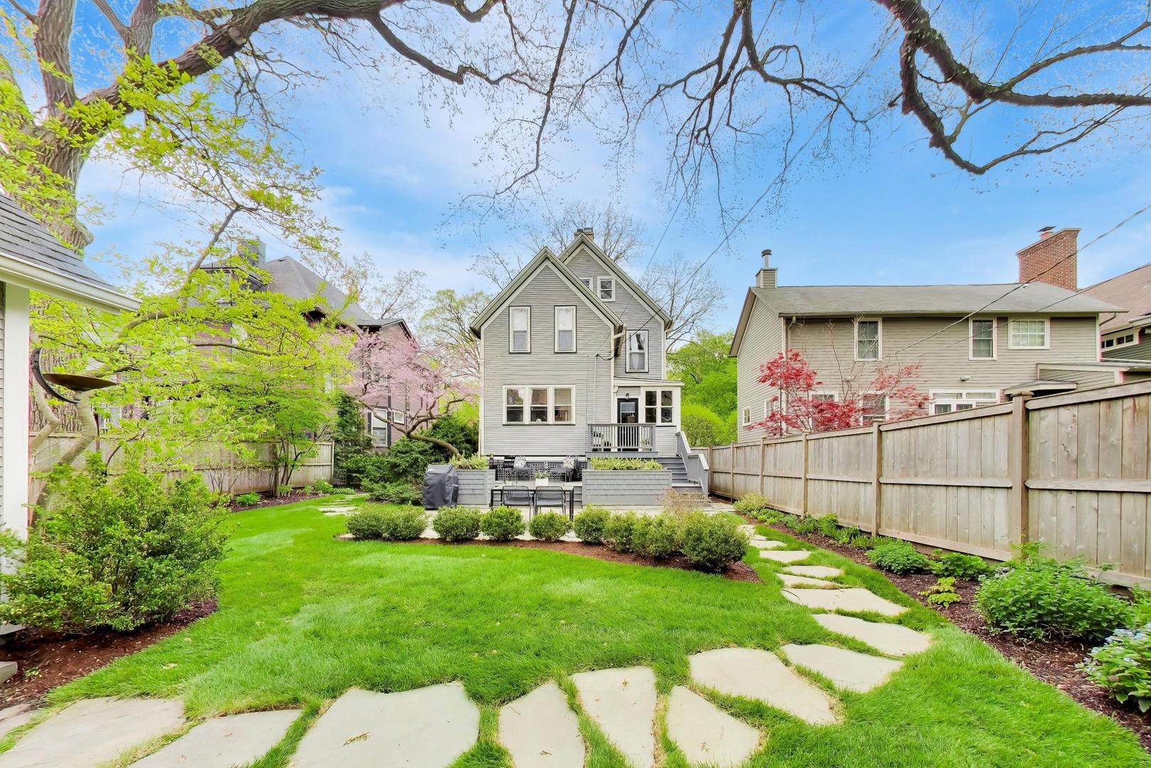 1235 Maple Avenue Evanston, IL 60202 - Photo 53 of 57 a front view of a house with a big yard and potted plants