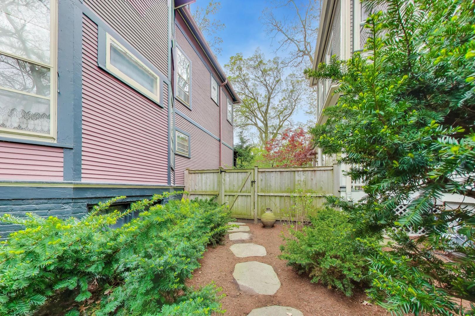 1235 Maple Avenue Evanston, IL 60202 - Photo 56 of 57 a view of a backyard with plants and a bench