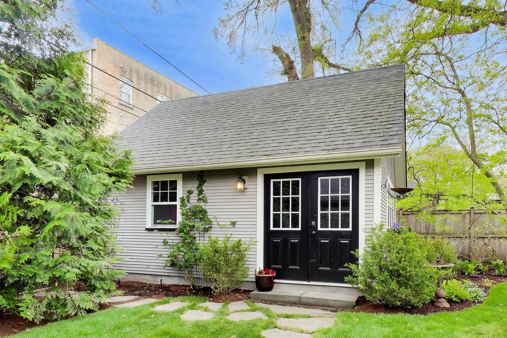 1235 Maple Avenue Evanston, IL 60202 - Photo 57 of 57 a front view of a house with a yard and potted plants