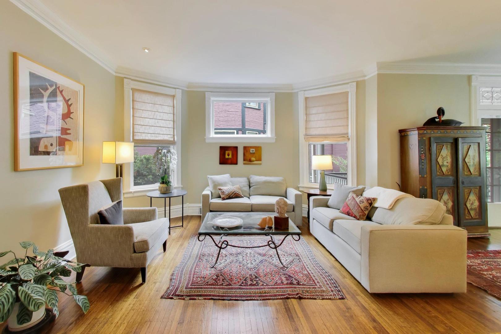 1235 Maple Avenue Evanston, IL 60202 - Photo 9 of 57 a living room with furniture wooden floor and a large window