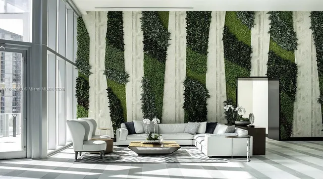 a living room with furniture and large windows