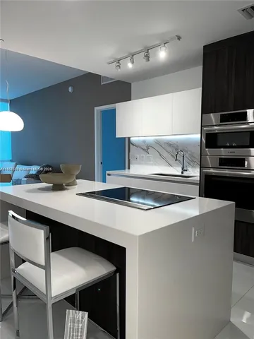 a kitchen with stainless steel appliances a sink stove and refrigerator