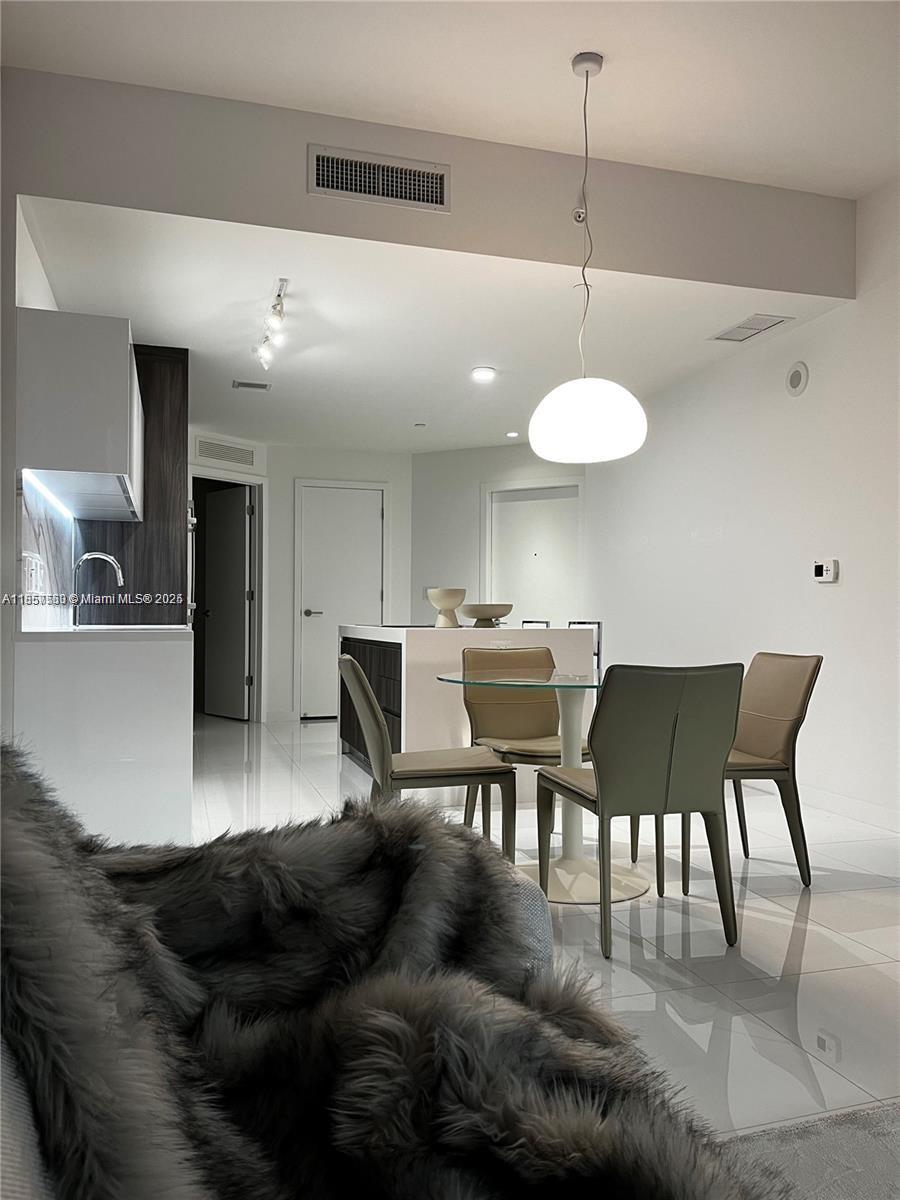 851 Northeast 1st Avenue, Unit 808 Miami, FL 33132 - Photo 7 of 23 a view of a dining room with furniture