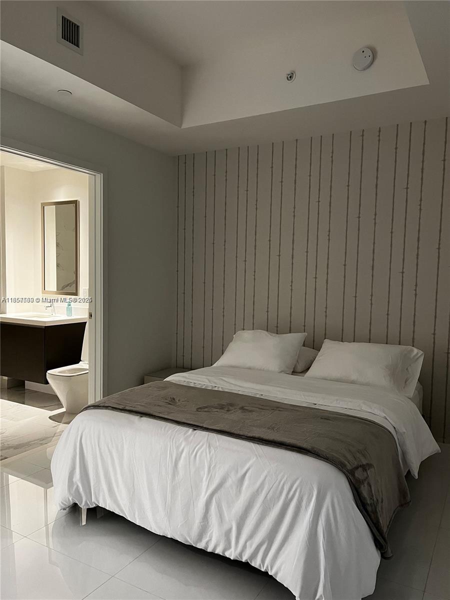 851 Northeast 1st Avenue, Unit 808 Miami, FL 33132 - Photo 8 of 23 a bedroom with a bed and window