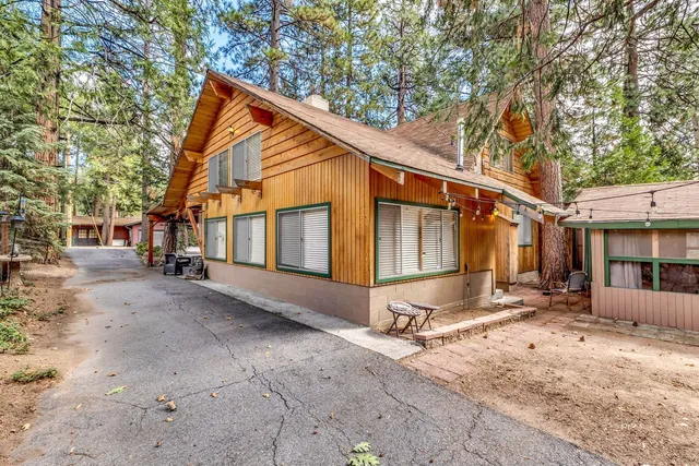 a view of a dining room with furniture and a chandelier