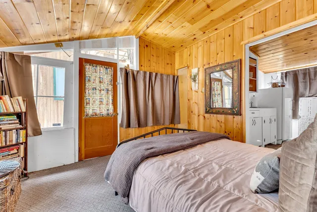 a front view of a house with yard and trees